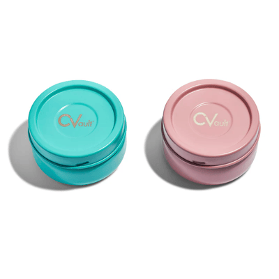 Blue Dream and Rose Quartz CVault cannabis containers on a white background.
